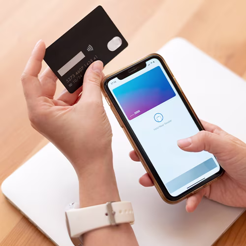 Mobile phone and credit card in hands